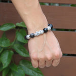 Wish-fulfilling (Ruyi) bead detail on obsidian bracelet
