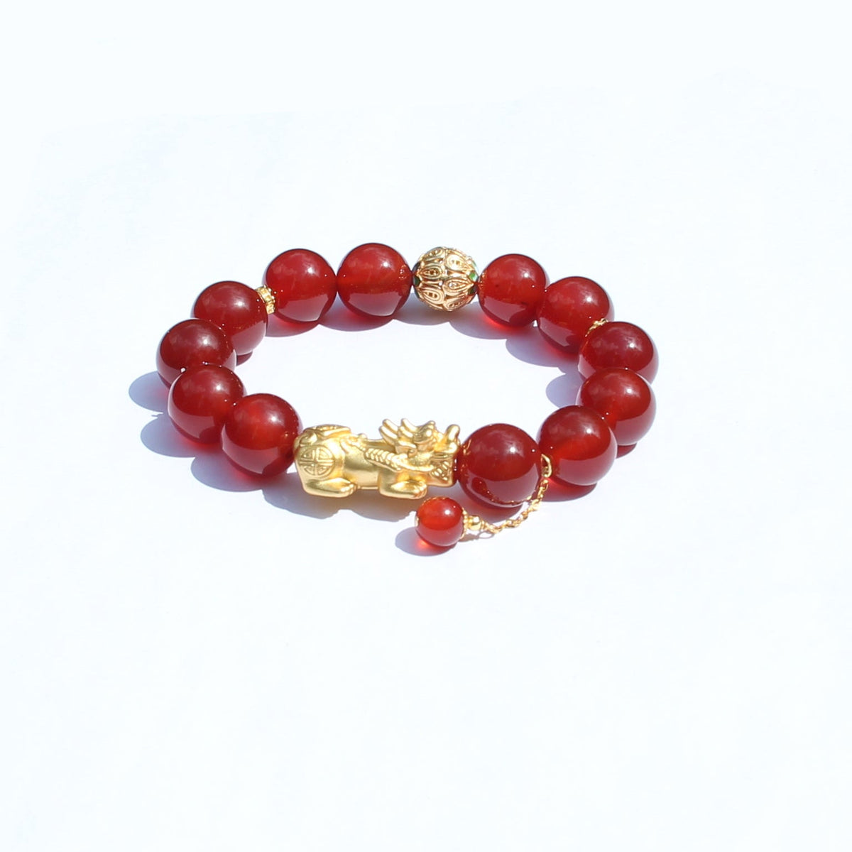 Gold-plated 925 Pixiu charm detail on red agate bracelet