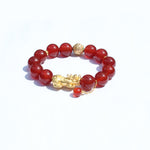 Gold-plated 925 Pixiu charm detail on red agate bracelet