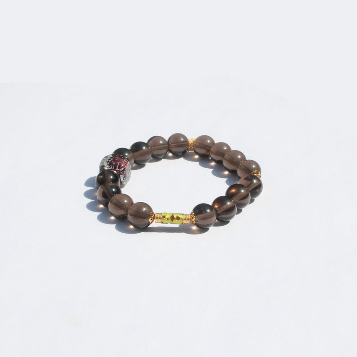 Gold-plated 925 silver accent detail on smoky quartz bracelet